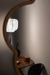 A study space featuring a wooden table with a lamp and an open book.