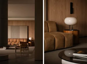 Modern living room featuring a cozy sofa and armchair with a wooden wall and floor, illuminated by a spherical lamp.