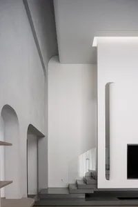 Modern interior design featuring concrete, glass, and wooden elements.