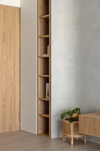 A minimalist interior design featuring wooden shelves and a textured wall.