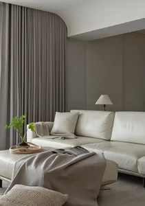 A minimalist living room featuring a couch, plants, and curtains.