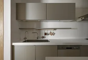A modern residential kitchen with metallic finishes and a sleek, minimalist design.