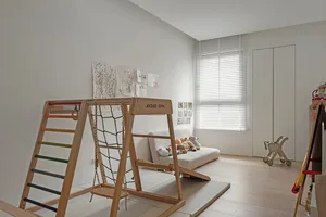 Modern children's room featuring a play space with wooden equipment and a couch.
