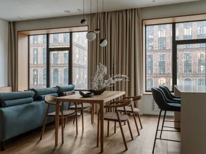 A modern minimalist dining room featuring wood furniture and glass windows.
