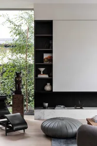 Modern living room featuring marble and concrete materials.