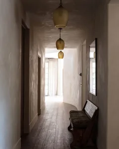 A minimalist interior hallway with neutral tones and natural light.