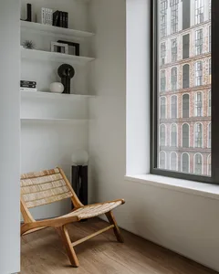 Modern living room with wooden furniture, woven fiber accents, and metal elements.