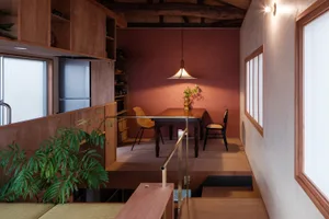 A minimalist residential space featuring wooden elements and an earthy color palette.