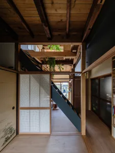 A minimalist wooden interior with a staircase and other architectural elements.