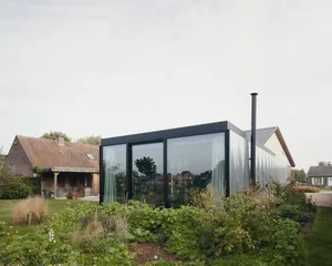 Modern architectural extension with glass and curtains
