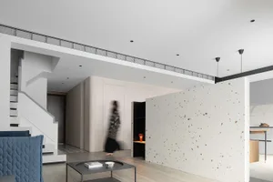 A modern interior featuring a terrazzo floor and minimalist design.