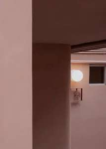 A modern interior design featuring concrete walls and circular lighting fixtures.