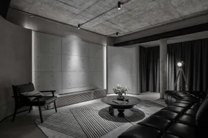 A stylish industrial living room with concrete walls and modern lighting features.