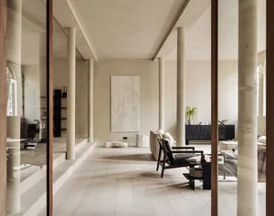 A minimalist living room featuring wood and concrete materials.