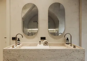 Modern bathroom with marble sink, concrete wall, and minimalist design.