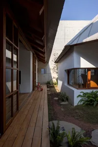 Modern house exterior featuring wooden facade and concrete wall