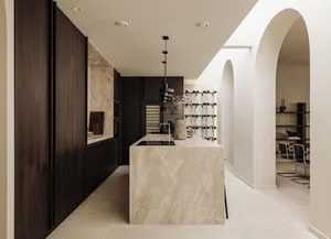 Modern kitchen featuring a marble countertop and dark wood cabinets
