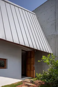 Modern building with a concrete exterior and white metal awning.