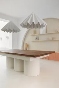 a modern commercial space with a wooden table and concrete floor