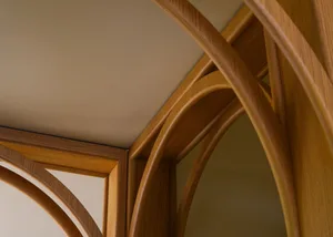 A close-up view of wooden architectural trusses in an interior setting.