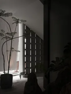 A minimalist interior space featuring concrete and glass materials.