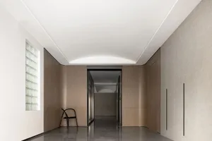 A modern interior corridor featuring wooden walls and a sleek design.