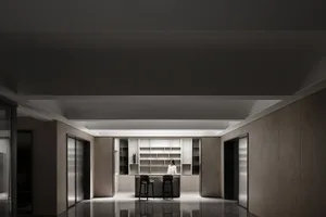 An interior space featuring a modern kitchen with minimalist design, including concrete walls and floor, and a sleek, functio