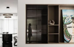 A modern living room featuring a sleek storage unit with glass doors and wooden accents.