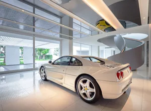 A modern office lobby with glass walls and a white marble floor.