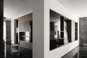 A stylish living space featuring modern metallic black glass panels on the wall and floor.