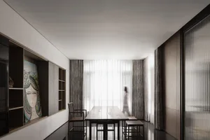 A minimalist dining room with a wooden table, chairs, and curtains.