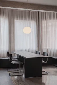 A modern minimalist interior design featuring concrete, wood, and steel materials.