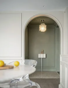 A modern minimalist kitchen with a glass countertop, featuring sleek lines and a clean, uncluttered design.