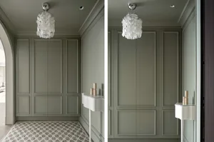 View of an elegant entrance featuring metallic shell lighting panels on the wall.