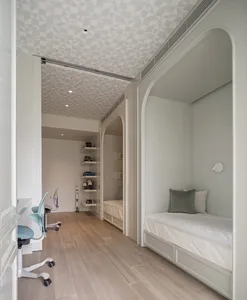 A minimalist bedroom featuring wooden furniture and painted walls.