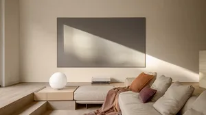 A minimalist living room with a contemporary couch, geometric light, and earthy tones.