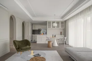 A modern apartment featuring a living room, kitchen, and dining area with minimalist design.