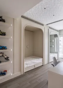 A modern minimalist bedroom with a built-in bunk bed and a desk area.