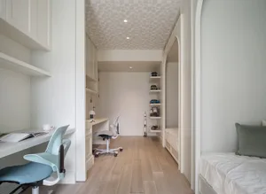 A modern minimalist bedroom with wood flooring and furniture.