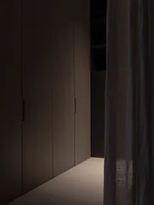A modern minimalist interior space with dark neutral colors