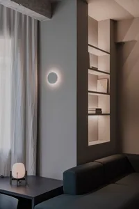 A minimalist residential space featuring concrete and white materials.