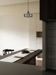 A modern kitchen with wooden elements and a minimalist design.