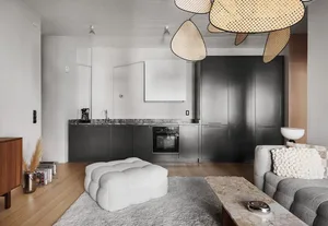Modern living room with marble flooring and wooden accents, featuring a comfortable seating area and a sleek kitchen in the b