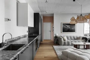 modern living space with marble countertops and beige sofa