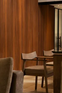 Modern restaurant interior with wooden furniture and seating.