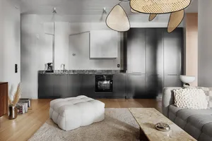 Modern minimalist residential kitchen featuring sleek metallic cabinets, a marble countertop, and a cozy seating area with a