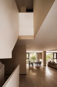 Modern dining room with sandstone surfaces and minimalist design.