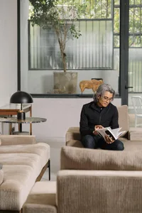 A modern interior space featuring contemporary sofas, glass tables, and leather chairs.