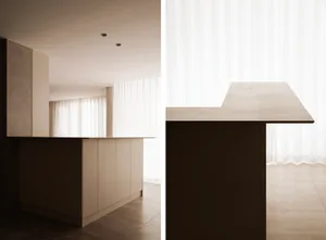 A modern kitchen with concrete countertops and minimalist design.