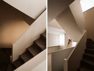 Modern interior design featuring a minimalist staircase with marble steps.